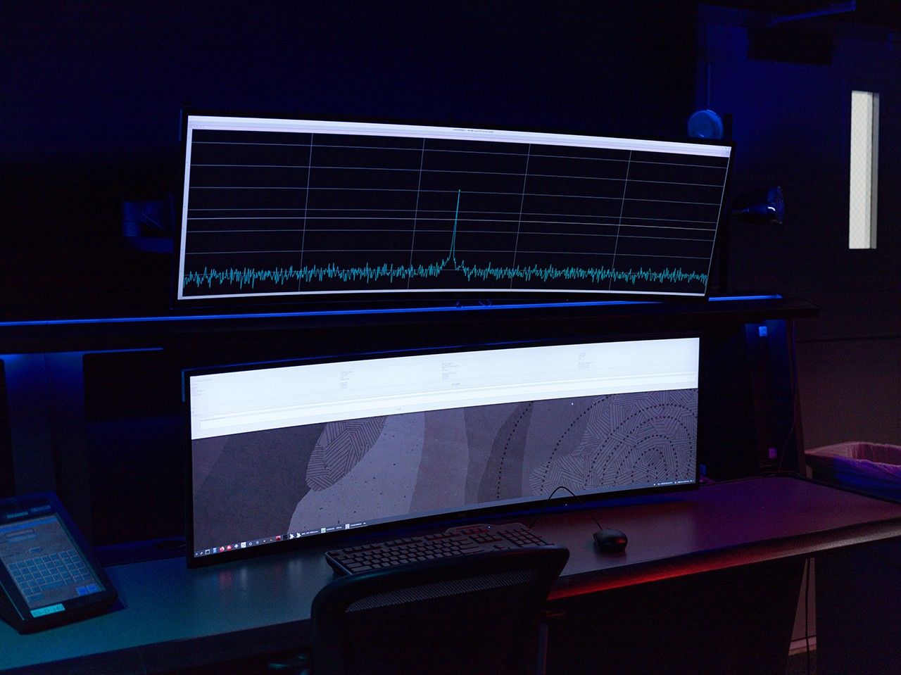 The acquisition of the radio frequency signal from the Artemis II crewed mission to the Moon by NASA’s Deep Space Network (DSN) is indicated by the peak in the data signal shown on the top computer screen.